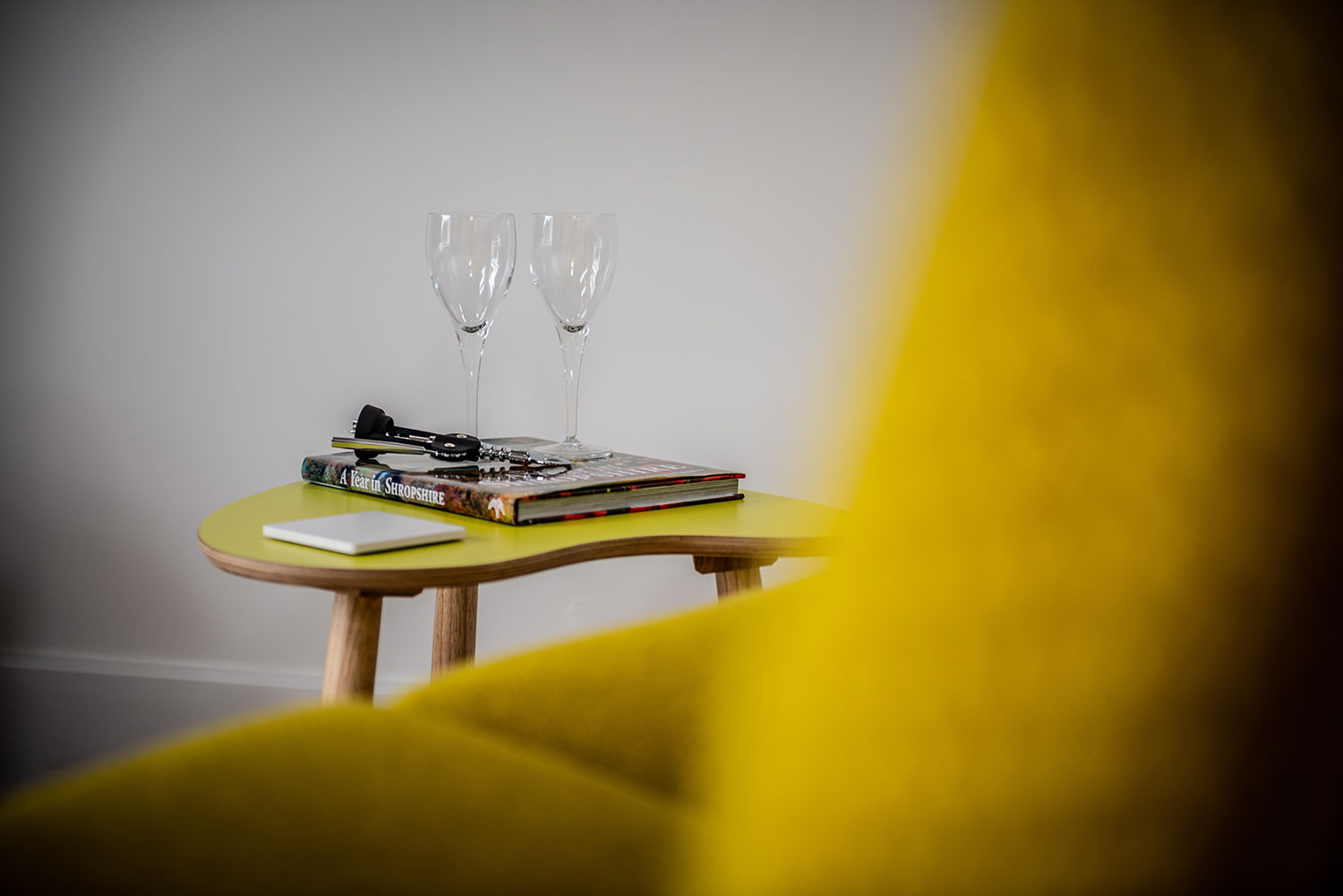 Comfy chair with book and wine glasses